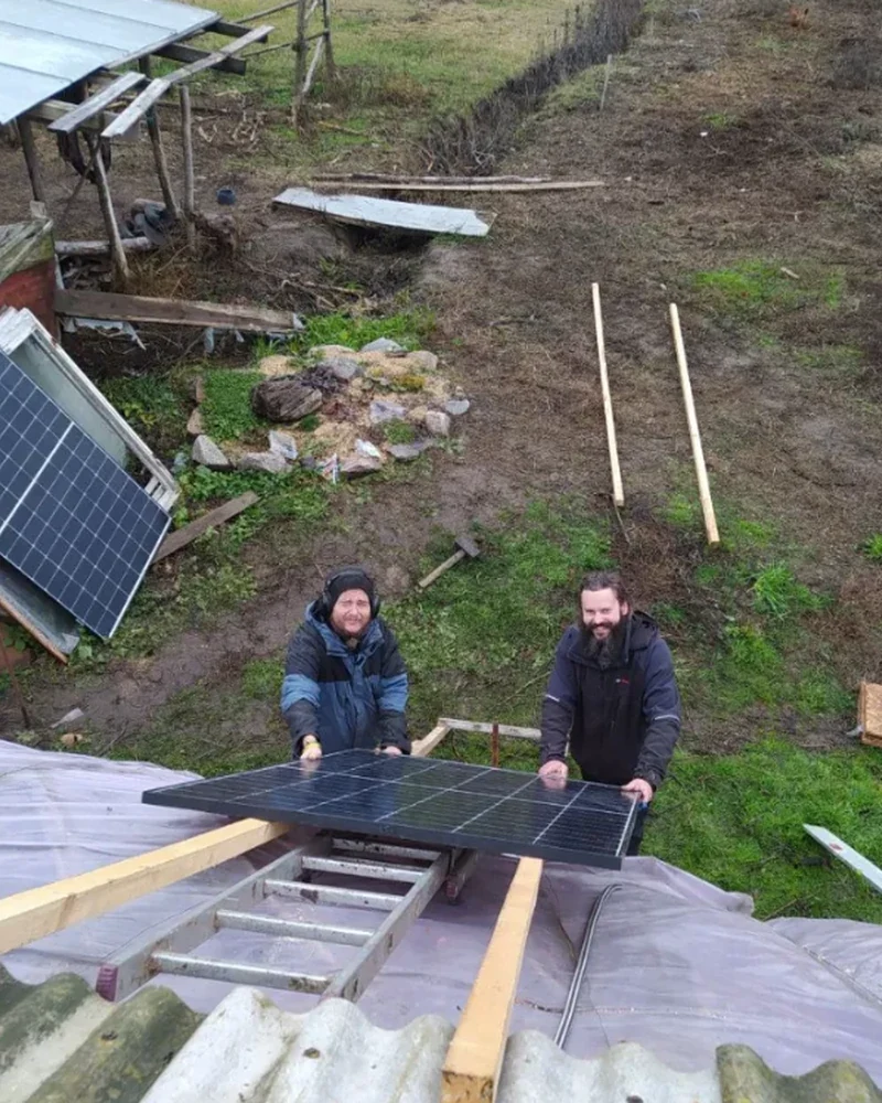 Team lifting a solar panel